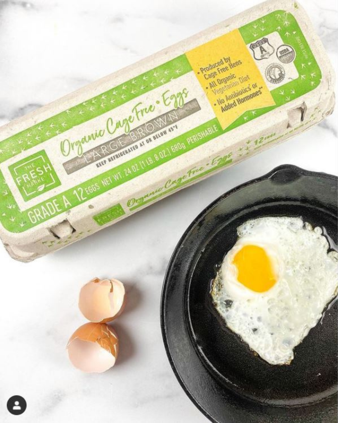 egg carton and fried egg in a cast iron pan