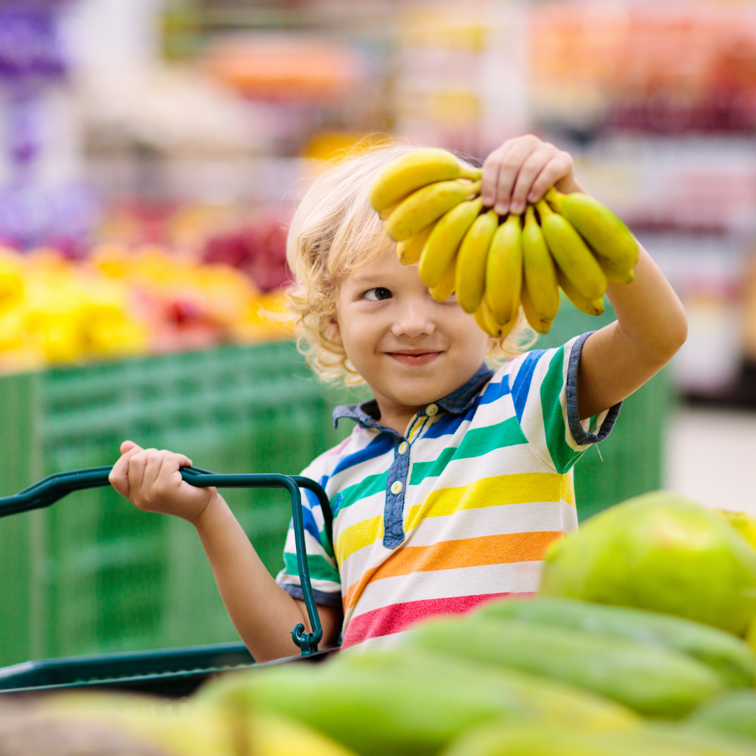 child holding bananas